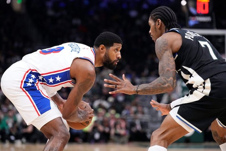 Paul George stares down Milwaukee Bucks guard Kevin Porter Jr. on Friday at Fiserv Forum.