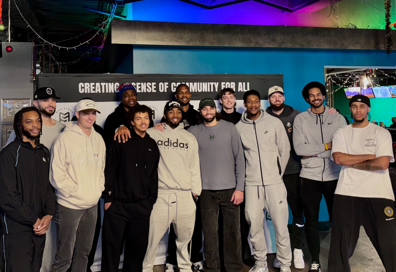 Cavs players pose with Max Strus at his second annual Bowl the Land event