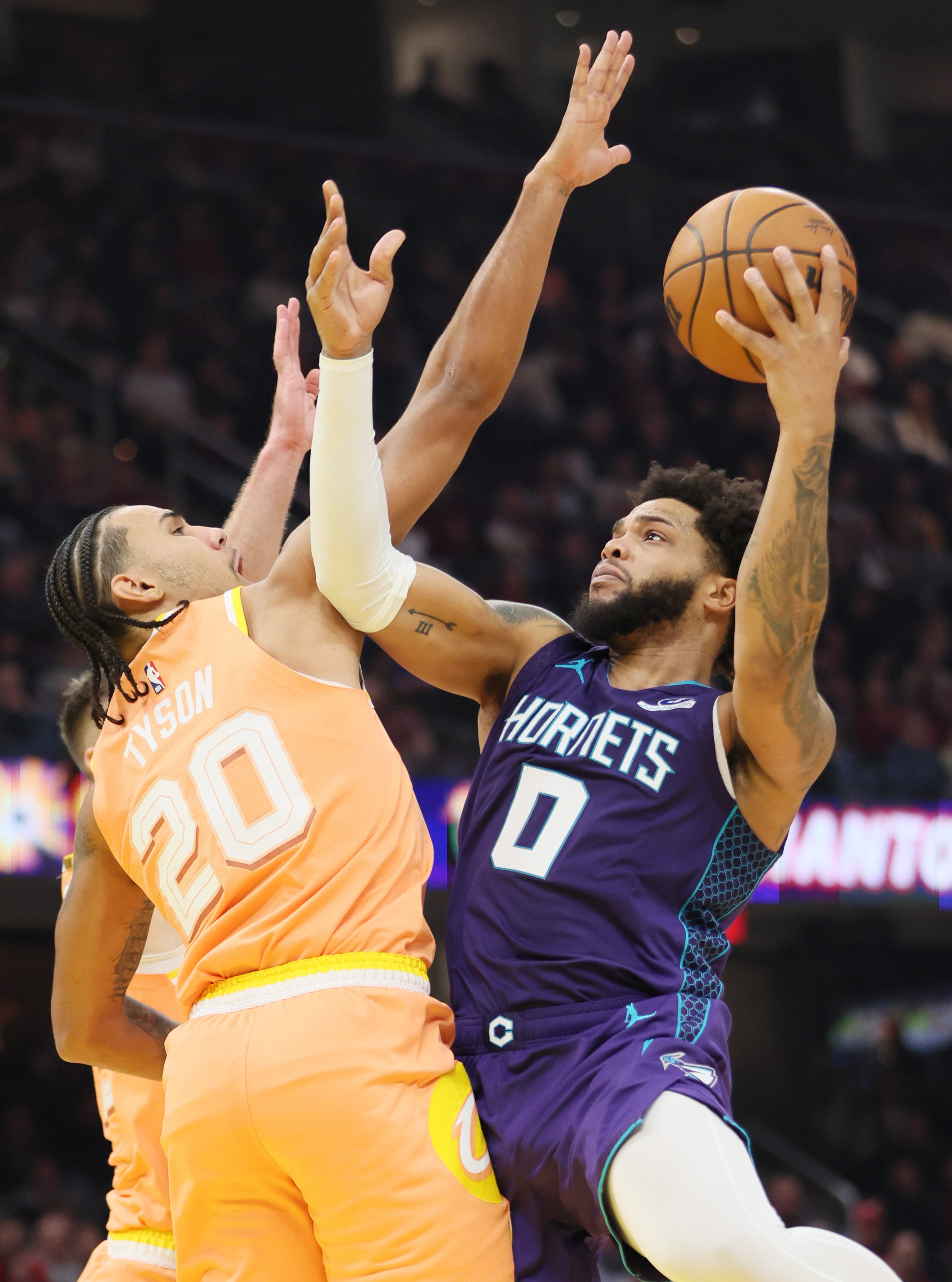 Charlotte Hornets forward Miles Bridges drives to the basket guarded by Cleveland Cavaliers guard Jaylon Tyson  in the first half at Rocket Arena. 