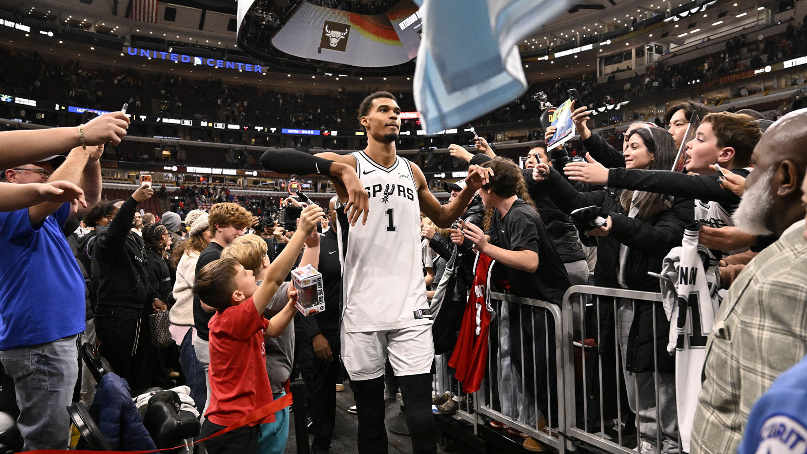 San Antonio Spurs forward Victor Wembanyama (1) greets fans after the second half against the Chicago Bulls at the United Center.