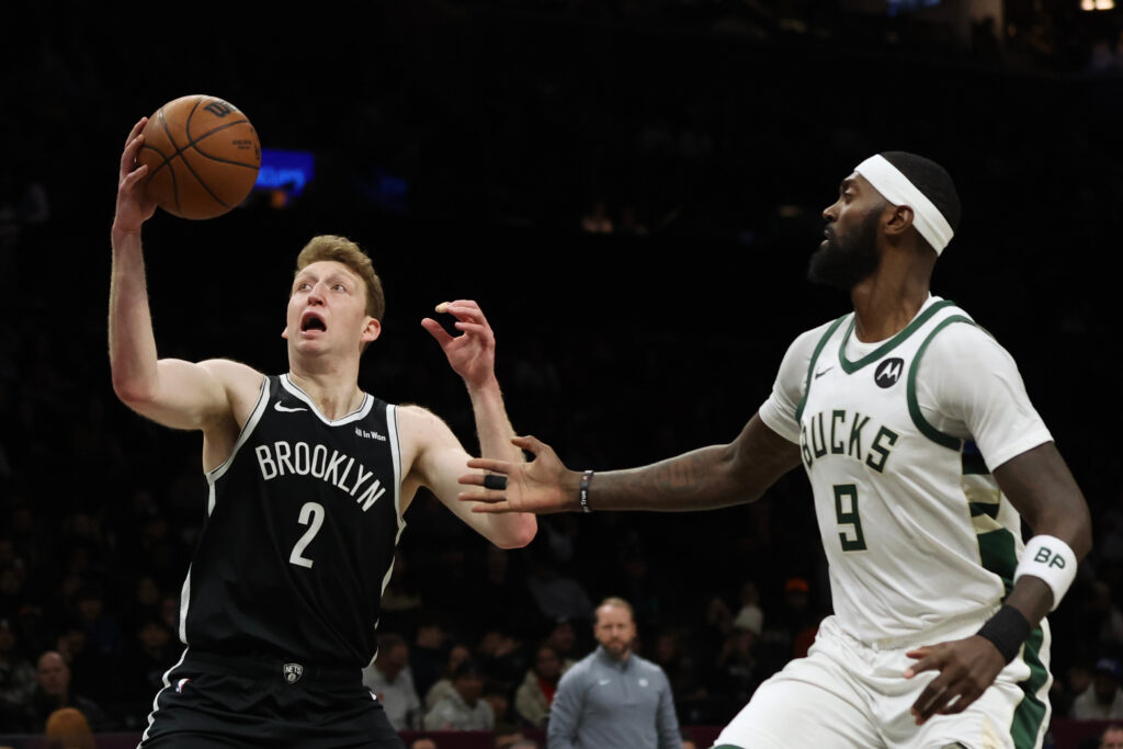 Brooklyn Nets forward Danny Wolf (2) drives to the basket past Milwaukee Bucks forward Bobby Portis (9) during the first half of an NBA basketball game, Sunday, Dec. 14, 2025, in New York. (AP Photo/Heather Khalifa)