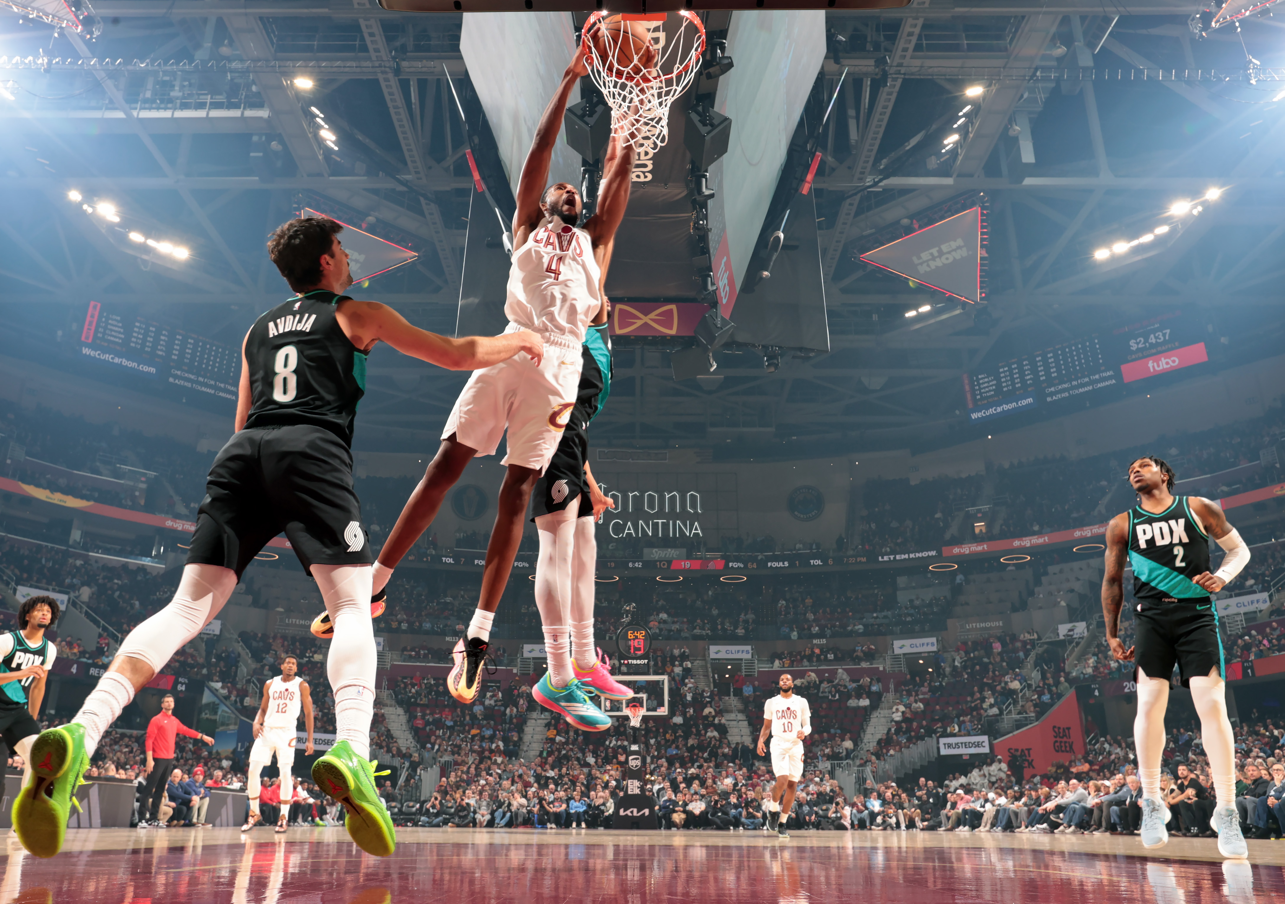 Cleveland Cavaliers center Evan Mobley hammers down a dunk over Portland Trail Blazers forward Toumani Camara in the first half of play. 