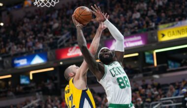 Celtics' Neemias Queta drives to the basket against the Pacers' Jay Huff in the first half.