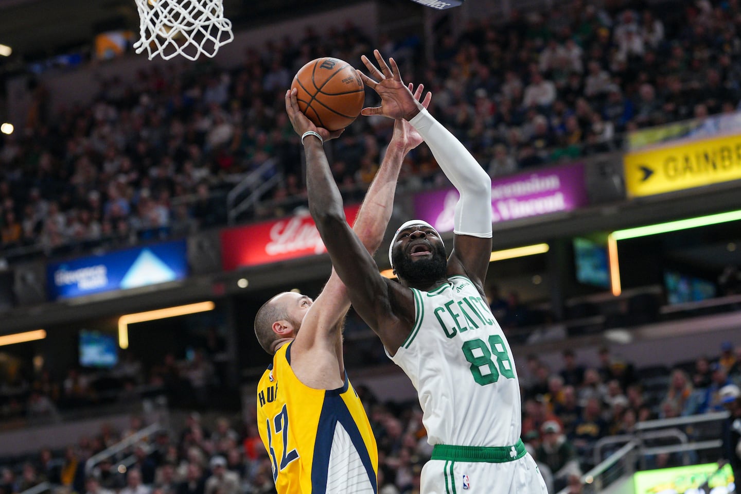 Celtics' Neemias Queta drives to the basket against the Pacers' Jay Huff in the first half.