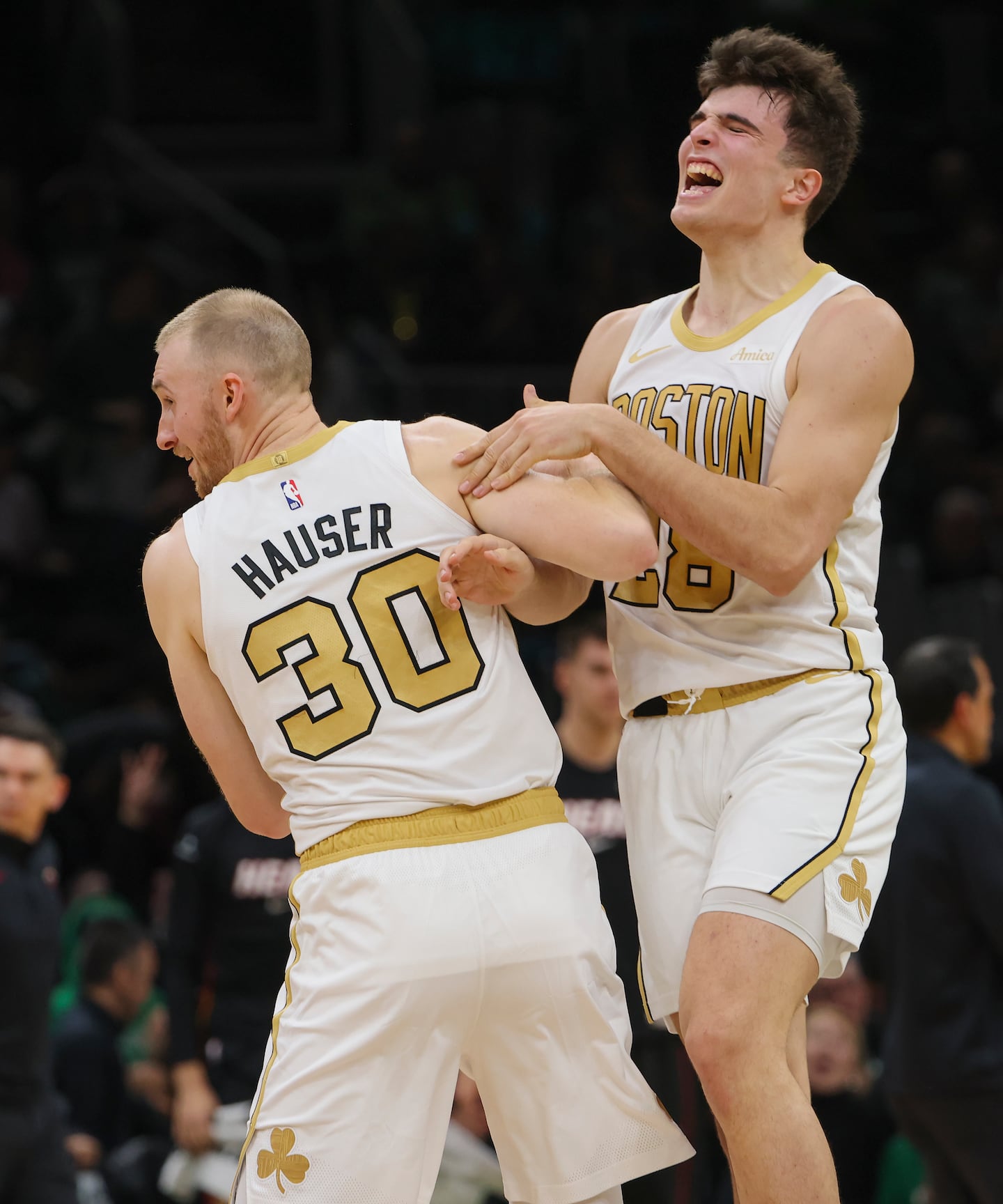 Hugo González (right) reacts after Sam Hauser made one of his four 3-pointers in the fourth quarter as the Celtics pulled away from the Heat.