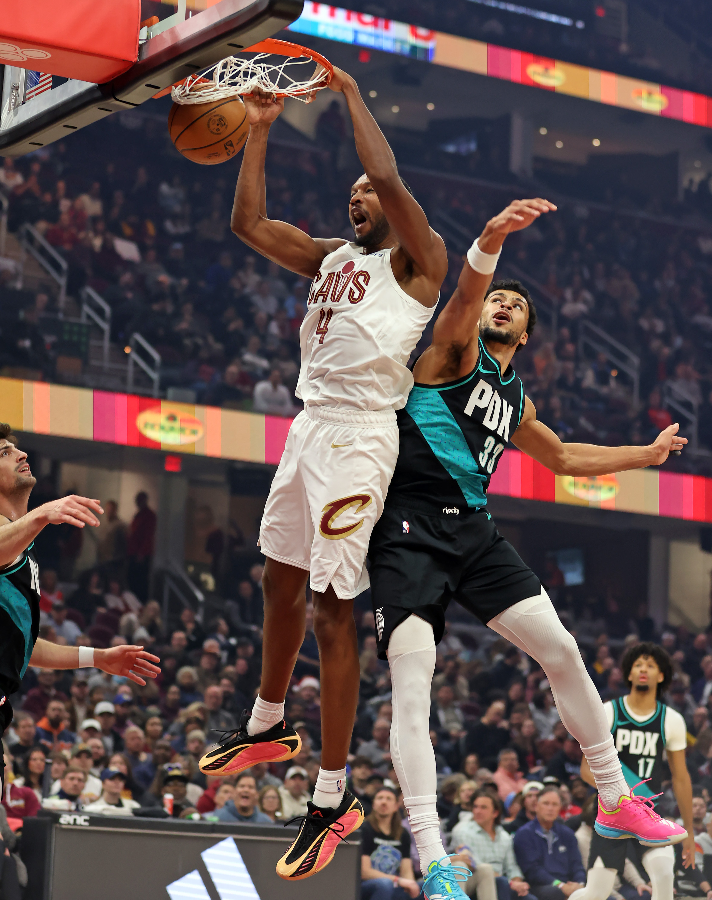 Cleveland Cavaliers center Evan Mobley hammers down a dunk over Portland Trail Blazers forward Toumani Camara in the first half of play. 