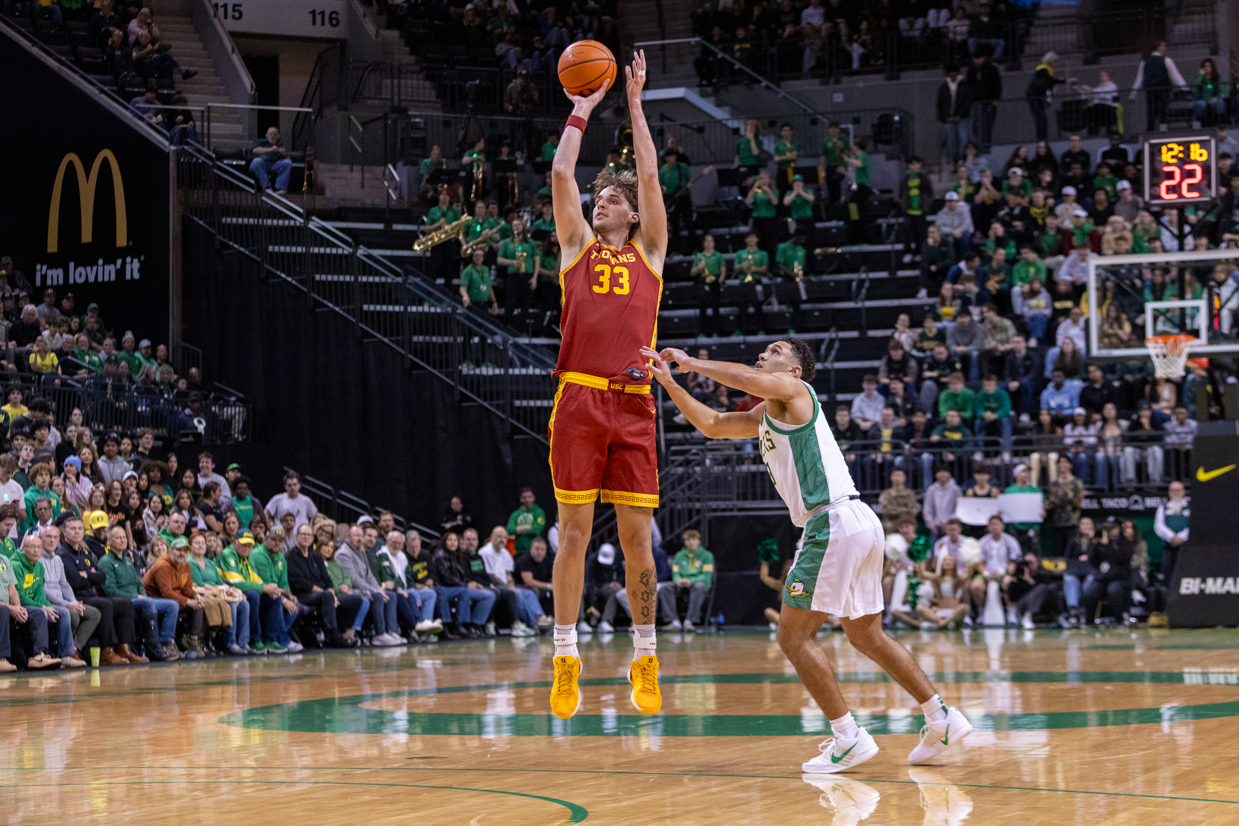 USC forward Jaden Brownell (#33) shoots a three-pointer over Oregon’s Jackson Shelstad as the Trojans face the Ducks in a Big Ten men’s college basketball at Matthew Knight Arena in Eugene on Tuesday, Dec. 2, 2025.