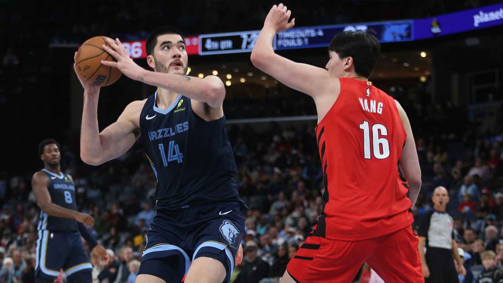 Memphis Grizzlies center Zach Edey (14) spins to the basket as Portland Trail Blazers center Yang Hansen (16) defends during the fourth quarter at FedExForum.