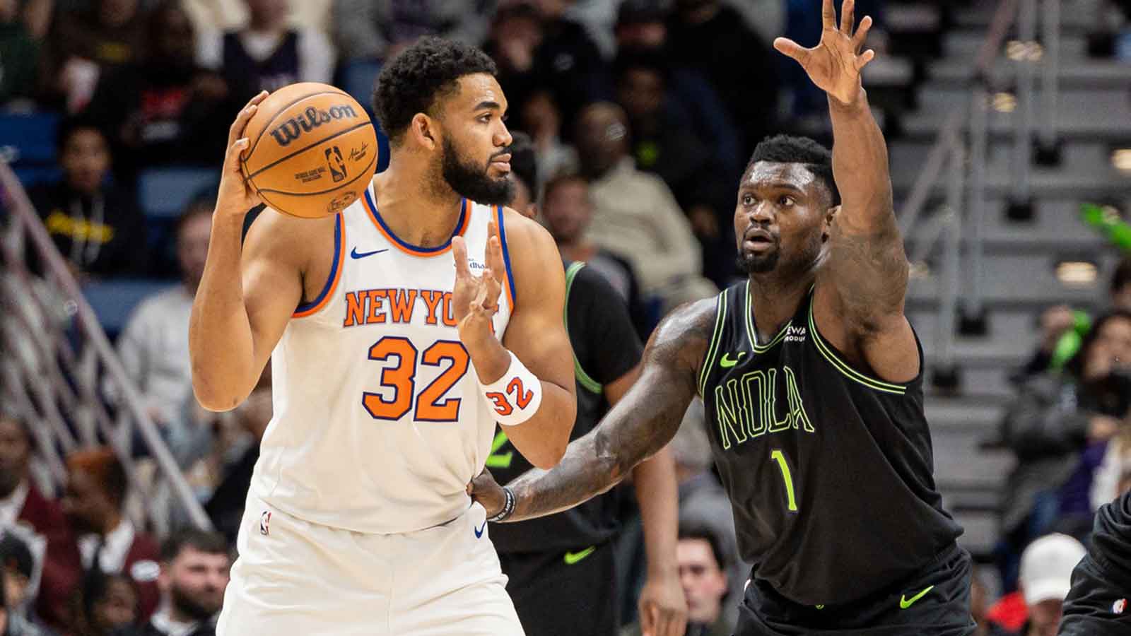 New York Knicks center/forward Karl-Anthony Towns (32) dribbles against New Orleans Pelicans forward Zion Williamson (1) during the second half at Smoothie King Center. 