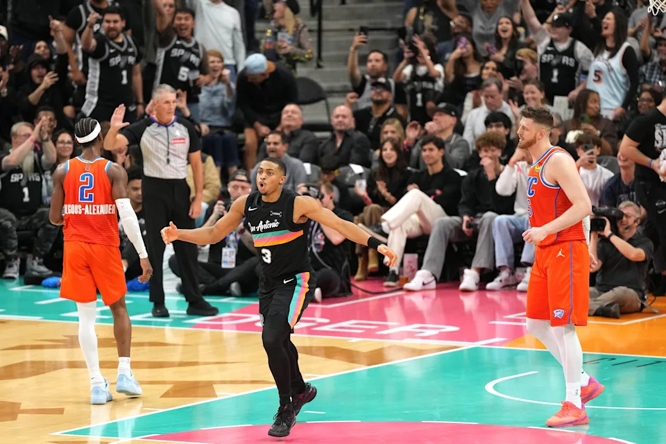 Dec 23, 2025; San Antonio, Texas, USA; San Antonio Spurs forwards Keldon Johnson (3) reacts after scoring a three point basket during the second half against the Oklahoma City Thunder at Frost Bank Center. Mandatory Credit: Scott Wachter-Imagn Images