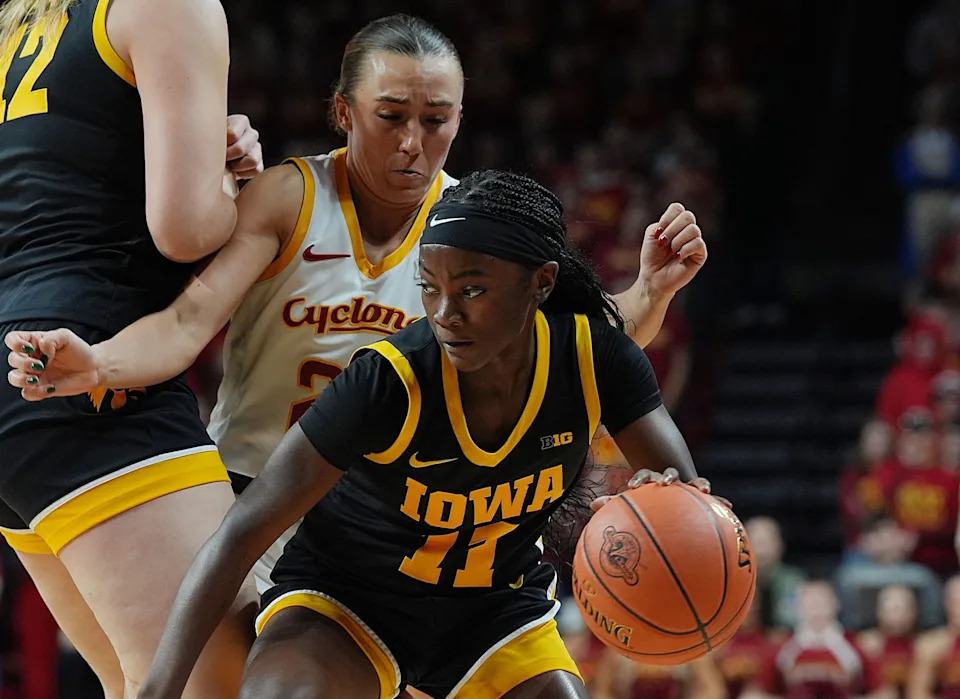 Iowa Hawkeyes guard Chazadi 'Chit-Chat' Wright (11) drives with the ball around Iowa State Cyclones' guard Reagan Wilson (22)during the first quarter in the NCAA women's basketball Cy-Hawk Series on Dec. 10, 2025, at Hilton Coliseum in Ames, Iowa.
