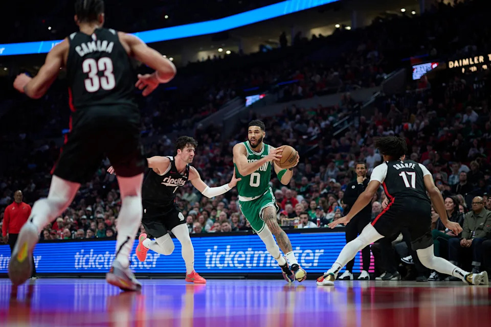 Mar 23, 2025; Portland, Oregon, USA; Boston Celtics forward Jayson Tatum (0) drives to the basket during the first half against Portland Trail Blazers forward Deni Avdija (8) at Moda Center. Mandatory Credit: Troy Wayrynen-Imagn Images