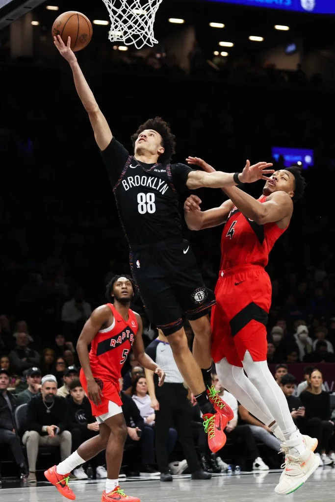 Brooklyn Nets’ Nolan Traore (88) drives to the basket past Toronto Raptors’ Scottie Barnes (4) during the second half of a game at the Barclays Center in Brooklyn, N.Y. on Sunday, Dec. 21, 2025. Heather Khalifa for the NY Post