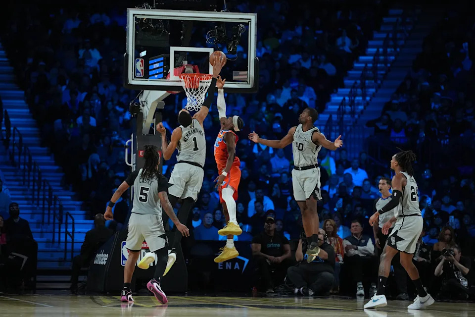 Dec 13, 2025; Las Vegas, Nevada, USA; San Antonio Spurs forward Victor Wembanyama (1) blocks the shot attempt by Oklahoma City Thunder guard Shai Gilgeous-Alexander (2) during the third quarter at T-Mobile Arena. Mandatory Credit: Kirby Lee-Imagn Images