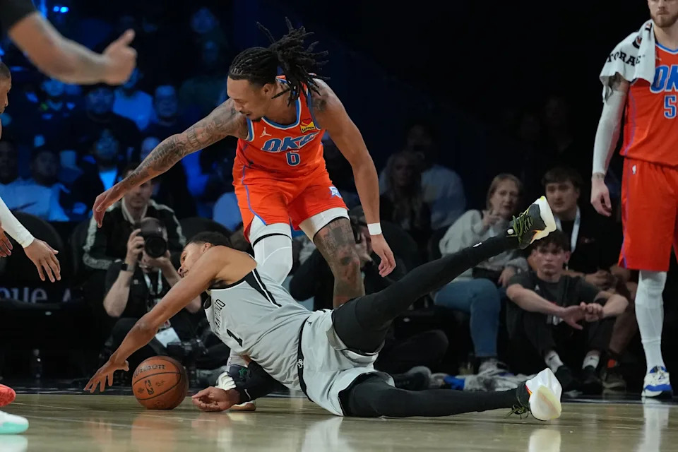 Dec 13, 2025; Las Vegas, Nevada, USA; Oklahoma City Thunder forward Jaylin Williams (6) and San Antonio Spurs forward Victor Wembanyama (1) battle for the loose ball during the second quarter at T-Mobile Arena. Mandatory Credit: Kirby Lee-Imagn Images