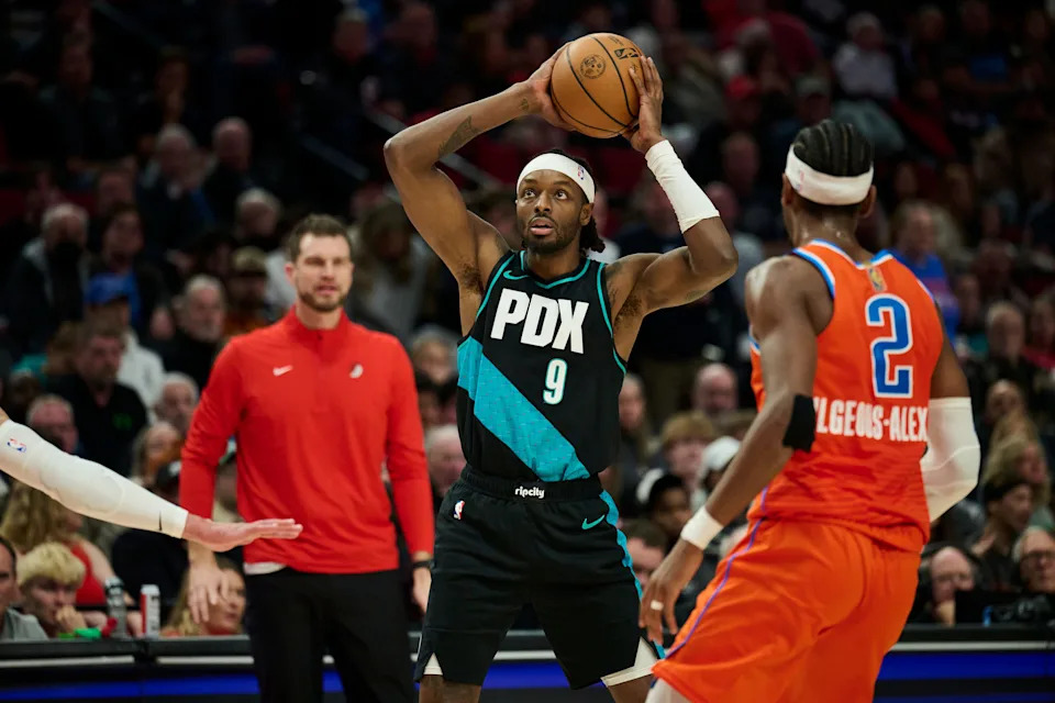 Nov 30, 2025; Portland, Oregon, USA; Portland Trail Blazers forward Jerami Grant (9) sets the play during the second half against Oklahoma City Thunder guard Shai Gilgeous-Alexander (2) at Moda Center. Mandatory Credit: Troy Wayrynen-Imagn Images