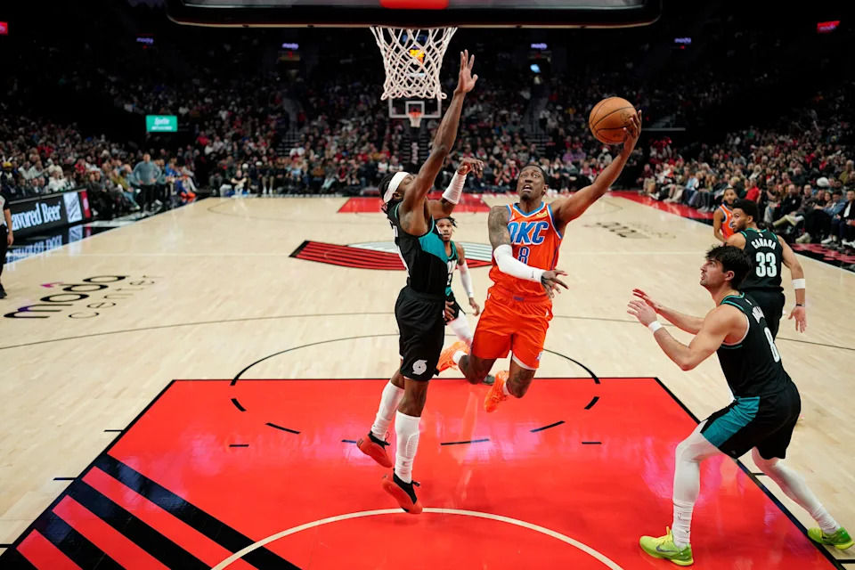 PORTLAND, OREGON - NOVEMBER 30: Jalen Williams #8 of the Oklahoma City Thunder lays up a shot against Jerami Grant #9 of the Portland Trail Blazers during the first half at Moda Center on November 30, 2025 in Portland, Oregon. NOTE TO USER: User expressly acknowledges and agrees that, by downloading and or using this photograph, User is consenting to the terms and conditions of the Getty Images License Agreement. (Photo by Soobum Im/Getty Images)