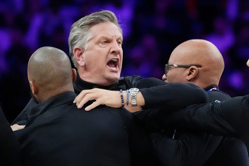 Dec 19, 2025; Minneapolis, Minnesota, USA; Staff restrains Minnesota Timberwolves head coach Chris Finch after a referee ejected him for chasing him down on a call for the Oklahoma City Thunder in the first quarter at Target Center. Mandatory Credit: Bruce Kluckhohn-Imagn Images