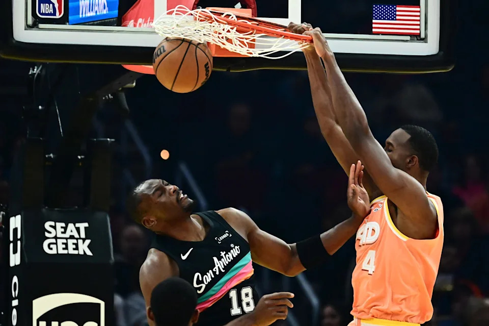 Cleveland Cavaliers center Evan Mobley (4) dunks over San Antonio Spurs center Bismack Biyombo (18) on Dec. 5, 2025, in Cleveland.