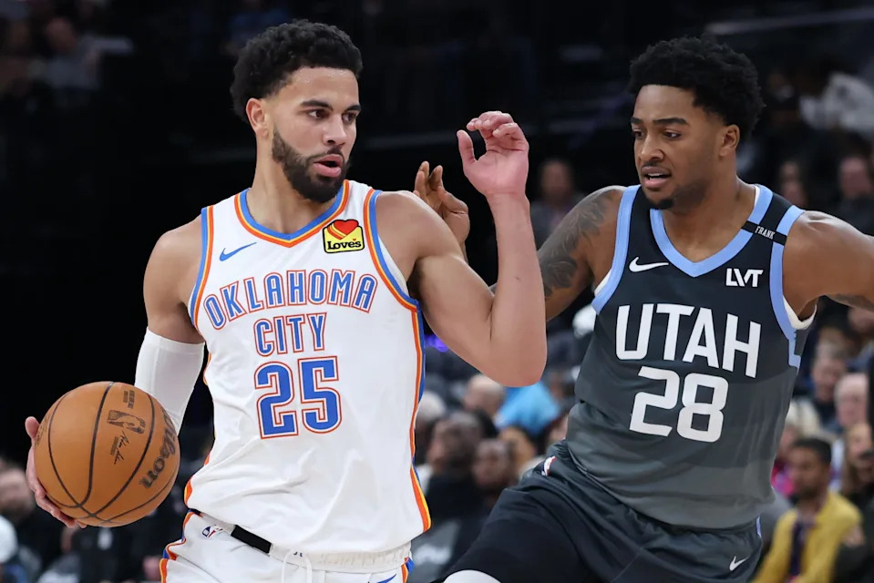 Dec 7, 2025; Salt Lake City, Utah, USA; Oklahoma City Thunder guard Ajay Mitchell (25) drives against Utah Jazz forward Brice Sensabaugh (28) during the first half at Delta Center. Mandatory Credit: Rob Gray-Imagn Images