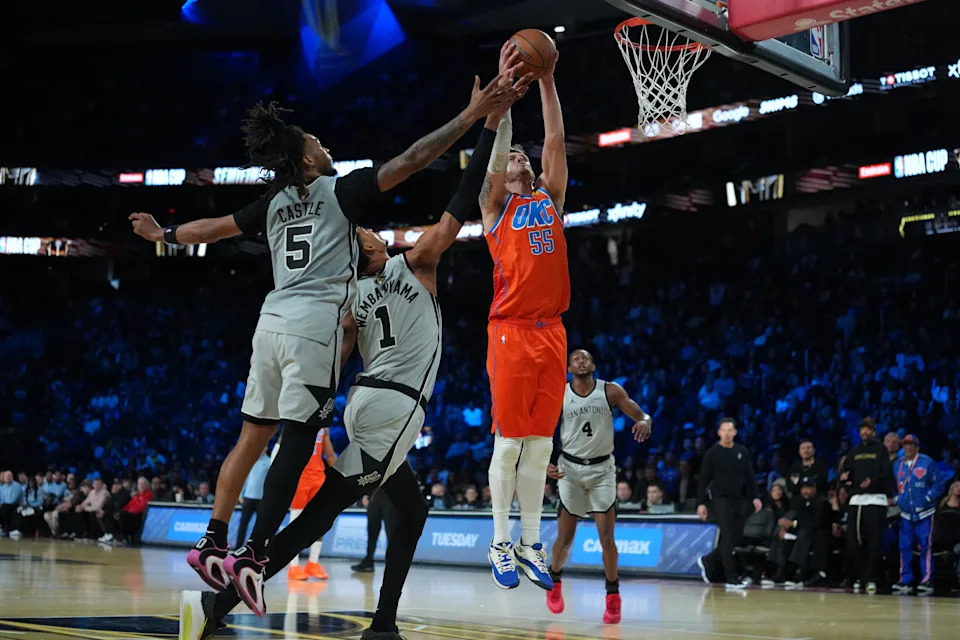 Dec 13, 2025; Las Vegas, Nevada, USA; Oklahoma City Thunder center Isaiah Hartenstein (55) grabs the rebound in front of San Antonio Spurs guard Stephon Castle (5) and forward Victor Wembanyama (1) during the second quarter at T-Mobile Arena. Mandatory Credit: Kirby Lee-Imagn Images