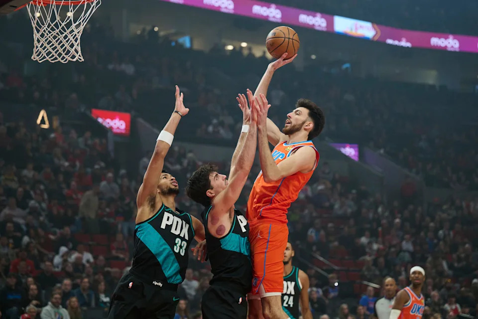 Nov 30, 2025; Portland, Oregon, USA; Oklahoma City Thunder center Chet Holmgren (7) shoots a basket during the first half against Portland Trail Blazers forward Deni Avdija (8) and forward Toumani Camara (33) at Moda Center. Mandatory Credit: Troy Wayrynen-Imagn Images