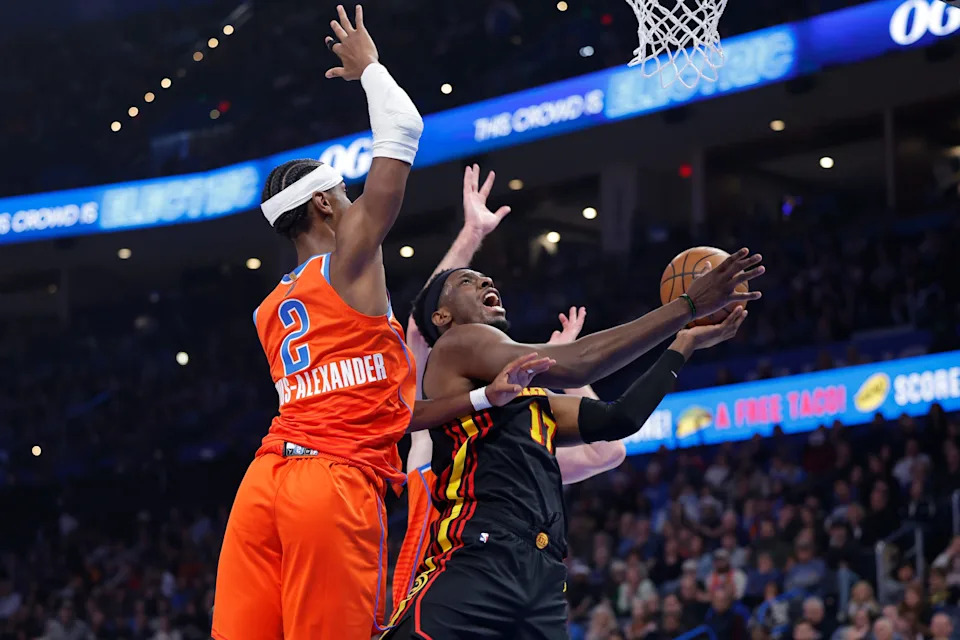 Dec 29, 2025; Oklahoma City, Oklahoma, USA; Atlanta Hawks forward Onyeka Okongwu (17) drives to the basket as Oklahoma City Thunder guard Shai Gilgeous-Alexander (2) defends during the first half at Paycom Center. Mandatory Credit: Alonzo Adams-Imagn Images