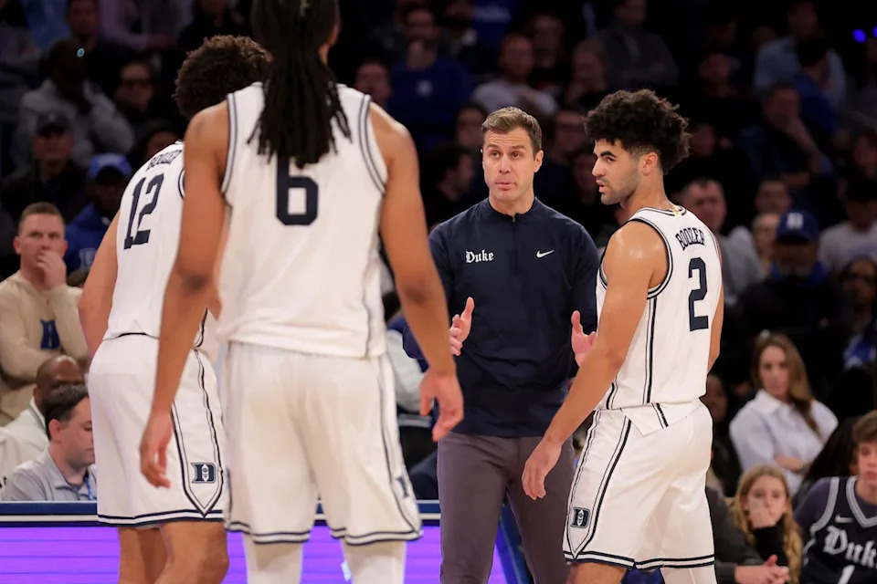 Dec 20, 2025; New York, New York, USA; Duke Blue Devils head coach Jon Scheyer talks to Duke Blue Devils forwards Cameron Boozer (12) and Maliq Brown (6) and guard Cayden Boozer (2) during the second half against the Texas Tech Red Raiders at Madison Square Garden. Mandatory Credit: Brad Penner-Imagn Images