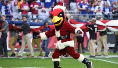 The Arizona Cardinals mascot, Big Red, runs on the field in a Santa Claus costume for the NFL game ...