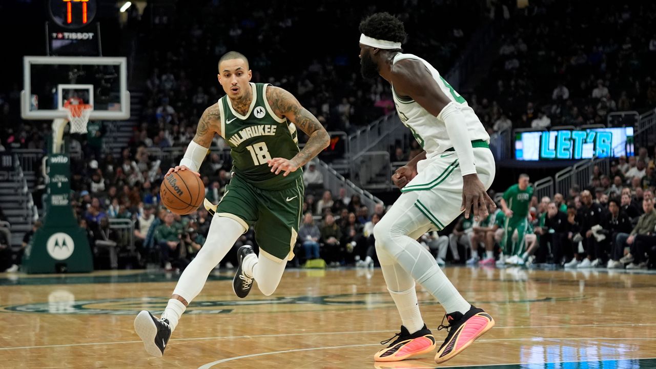Milwaukee Bucks' Kyle Kuzma (18) drives to the basket against Boston Celtics' Neemias Queta during the first half of an NBA basketball game Thursday, Dec. 11, 2025, in Milwaukee.
