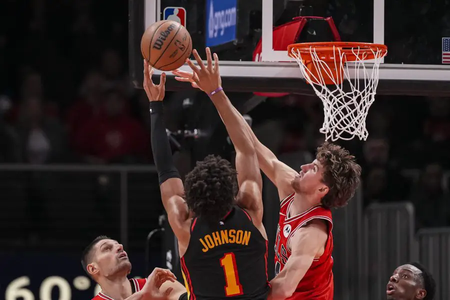 Dec 21, 2025; Atlanta, Georgia, USA; Chicago Bulls forward Matas Buzelis (14) defends a shot by Atlanta Hawks forward Jalen Johnson (1) during the second half at State Farm Arena. Mandatory Credit: Dale Zanine-Imagn Images