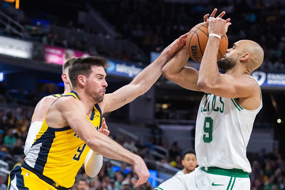 Dec 26, 2025; Indianapolis, Indiana, USA; Boston Celtics guard Derrick White (9) shoots the ball while Indiana Pacers guard T.J. McConnell (9) defends in the second half at Gainbridge Fieldhouse. Mandatory Credit: Trevor Ruszkowski-Imagn Images