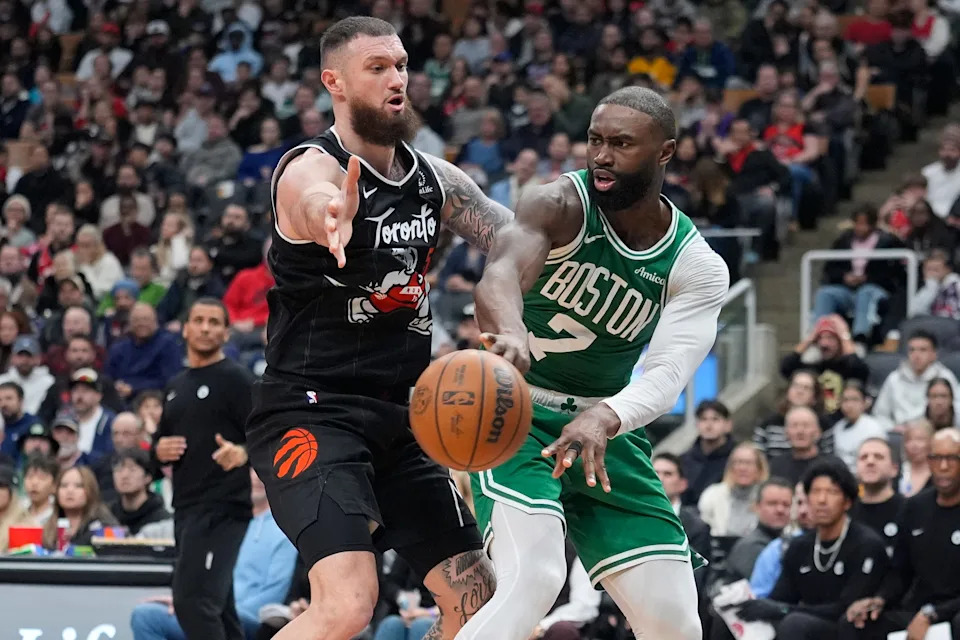 Dec 7, 2025; Toronto, Ontario, CAN; Boston Celtics forward Jaylen Brown (7) passes the ball against Toronto Raptors forward Sandro Mamukelashvili (54) during the second half at Scotiabank Arena. Mandatory Credit: John E. Sokolowski-Imagn Images