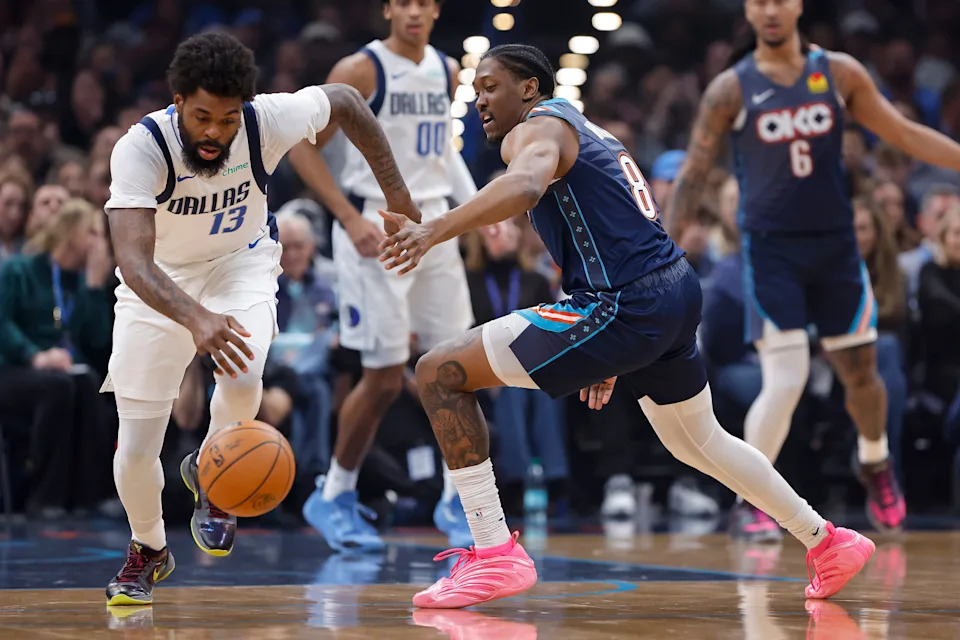 Dec 5, 2025; Oklahoma City, Oklahoma, USA; Dallas Mavericks forward Naji Marshall (13) and Oklahoma City Thunder guard Jalen Williams (8) reach for a loose ball during the first quarter at Paycom Center. Mandatory Credit: Alonzo Adams-Imagn Images