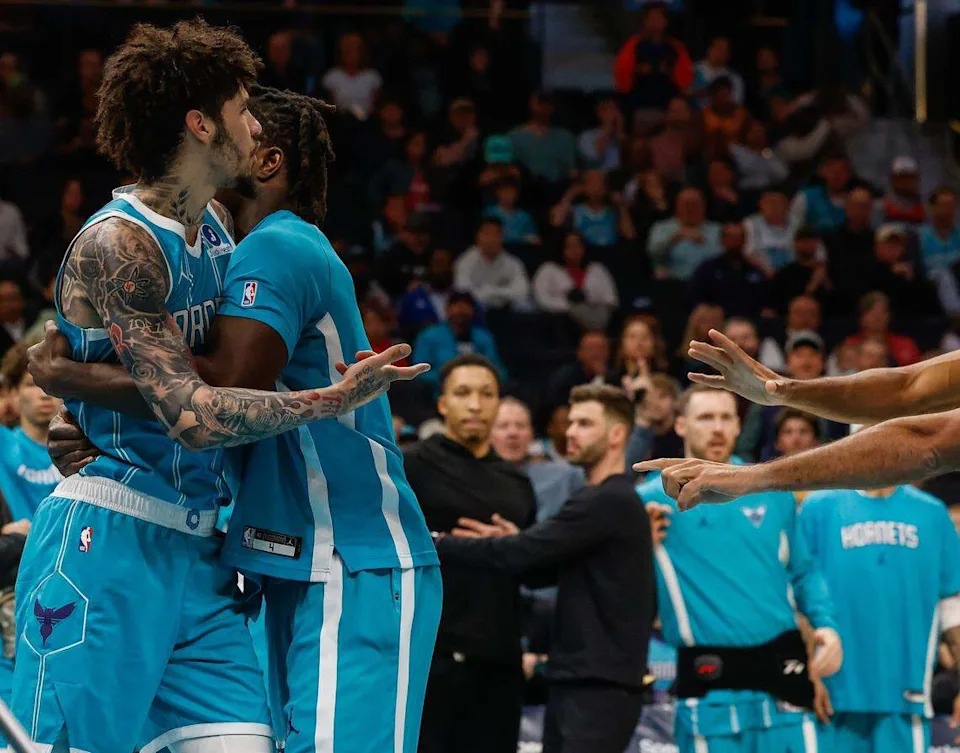 Hornets guard LaMelo Ball is held back by a teammate as he reacts after being pushed off the court  by Wizards’ guard Kyshawn George during Tuesday’s game at Spectrum Center.