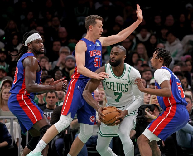 Boston Celtics guard Jaylen Brown (7) is surrounded by Detroit Pistons players Isaiah Stewart (28), Duncan Robinson (55) and Ronald Holland II during the first half. (By Matt Stone/Boston Herald)