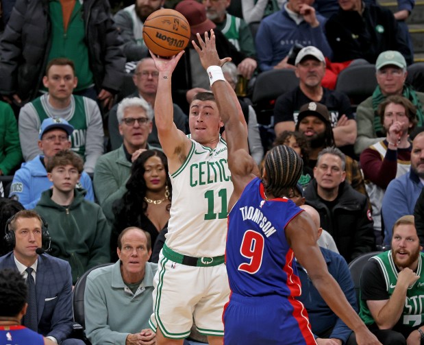 Boston Celtics guard Payton Pritchard (11) shoots a 3-pointer over Detroit Pistons guard Ausar Thompson during the first half of a NBA game. (Photo By Matt Stone/Boston Herald)