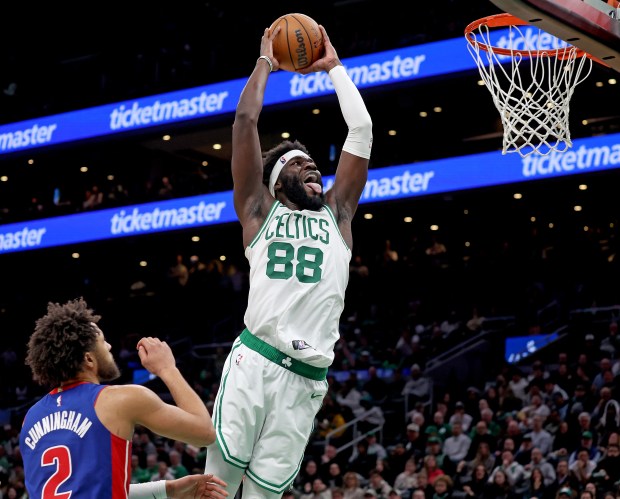 Boston, MA - December 15 - Boston Celtics center Neemias Queta (88) goes up for a dunk as Detroit Pistons guard Cade Cunningham (2) looks on during the second half of a NBA game. (Photo By Matt Stone/Boston Herald).