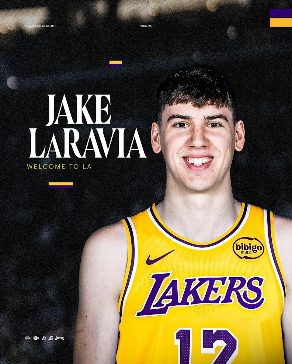 Jake LaRavia smiles in an official Los Angeles Lakers announcement graphic wearing the team’s yellow jersey