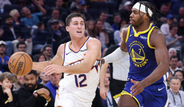 Collin Gillespie #12 of the Phoenix Suns is guarded by Buddy Hield #7 of the Golden State Warriors ...