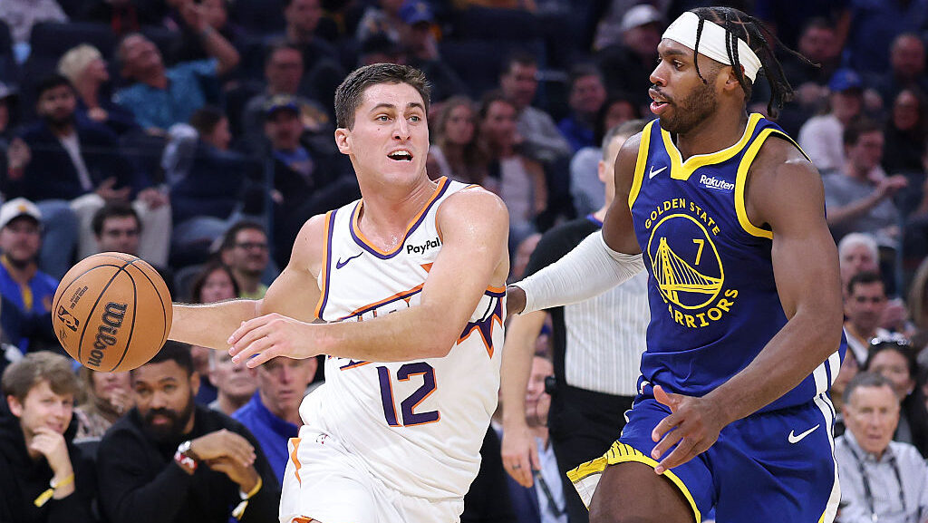 Collin Gillespie #12 of the Phoenix Suns is guarded by Buddy Hield #7 of the Golden State Warriors ...