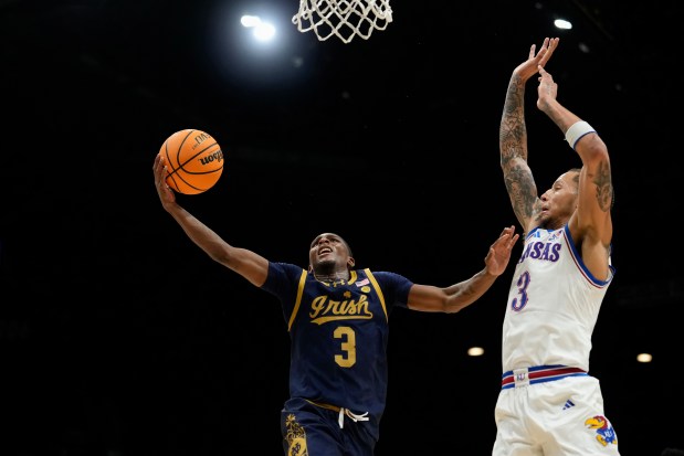 Notre Dame guard Markus Burton shoots a layup against Kansas guard Tre White on Monday, Nov. 24, 2025, in Las Vegas. (AP Photo/Lucas Peltier)