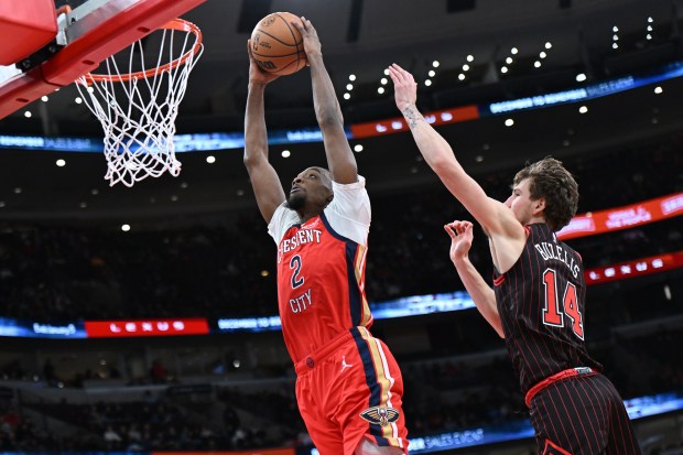 New Orleans Pelicans' Herb Jones (2) goes up for a dunk against Chicago Bulls' Matas Buzelis (14) during the first half on Sunday, Dec. 14, 2025, in Chicago. (AP Photo/Paul Beaty)
