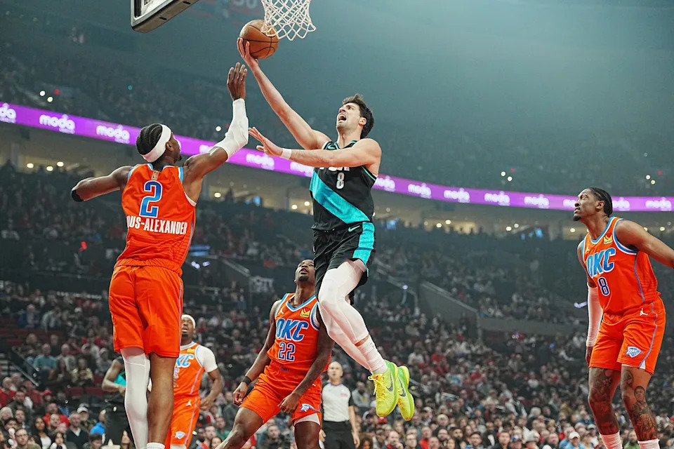 PORTLAND, OREGON - NOVEMBER 30: Deni Avdija #8 of the Portland Trail Blazers lays up a shot against Shai Gilgeous-Alexander #2 of the Oklahoma City Thunder during the first half at Moda Center on November 30, 2025 in Portland, Oregon. NOTE TO USER: User expressly acknowledges and agrees that, by downloading and or using this photograph, User is consenting to the terms and conditions of the Getty Images License Agreement. (Photo by Soobum Im/Getty Images)