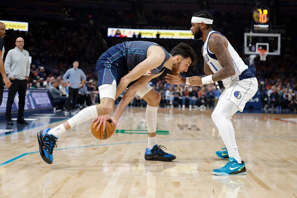 Dec 5, 2025; Oklahoma City, Oklahoma, USA; Oklahoma City Thunder center Chet Holmgren (7) moves the ball as Dallas Mavericks guard Jaden Hardy (1) defends during the second half at Paycom Center. Mandatory Credit: Alonzo Adams-Imagn Images