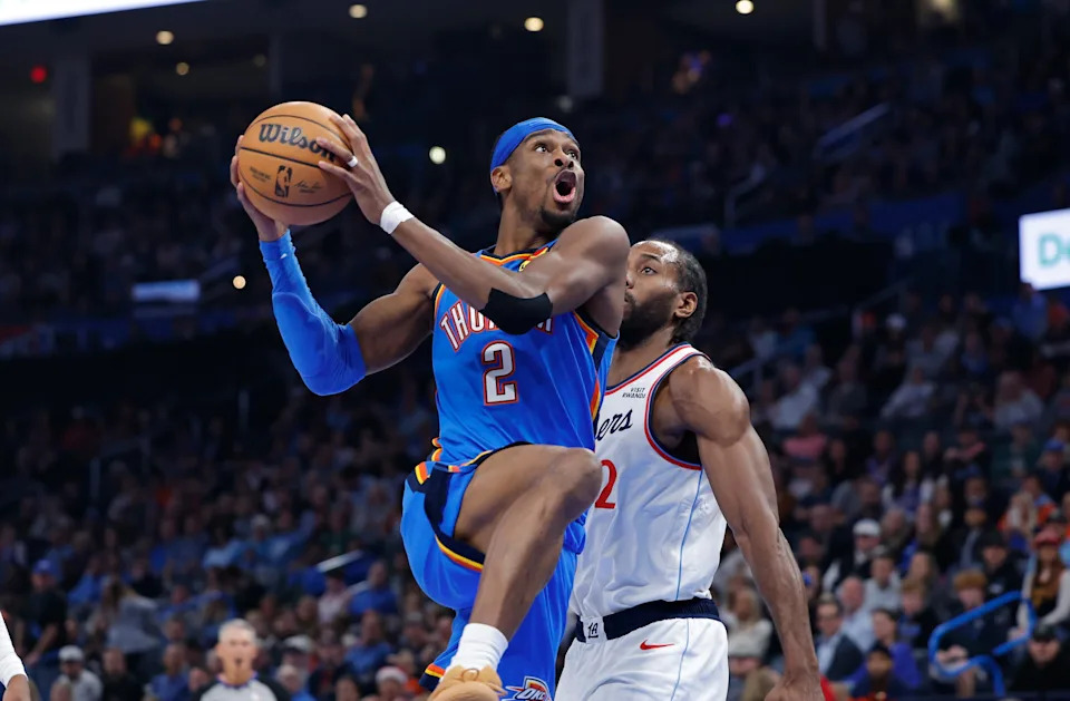 Dec 18, 2025; Oklahoma City, Oklahoma, USA; Oklahoma City Thunder guard Shai Gilgeous-Alexander (2) goes up for a basket beside Los Angeles Clippers forward Kawhi Leonard (2) during the second quarter at Paycom Center. Mandatory Credit: Alonzo Adams-Imagn Images