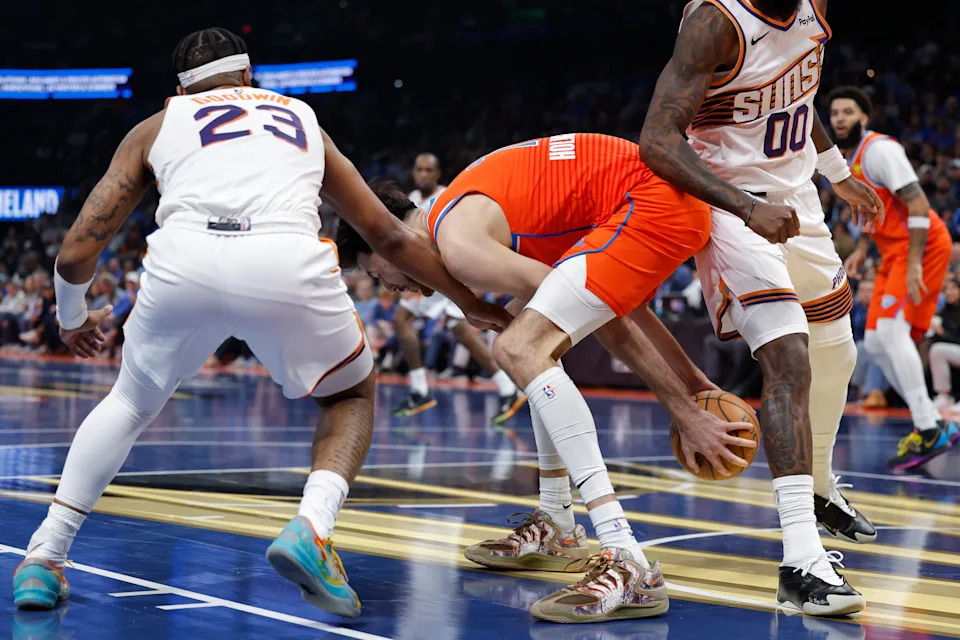 Dec 10, 2025; Oklahoma City, Oklahoma, USA; Oklahoma City Thunder center Chet Holmgren (7) grabs a rebound as Phoenix Suns guard Jordan Goodwin (23) reaches for the ball during the second quarter at Paycom Center. Mandatory Credit: Alonzo Adams-Imagn Images