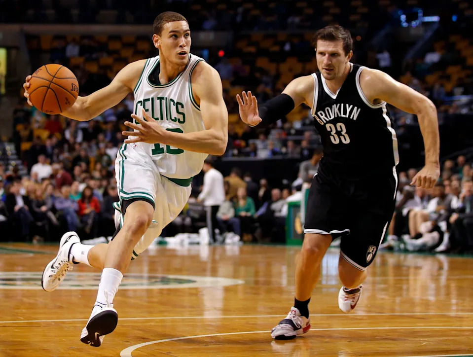 Oct 22, 2014; Boston, MA, USA; Boston Celtics forward Dwight Powell (12) drives the ball against Brooklyn Nets forward Mirza Teletovic (33) in the second half at TD Garden. The Celtics defeated the Nets 100-86. Mandatory Credit: David Butler II-USA TODAY Sports