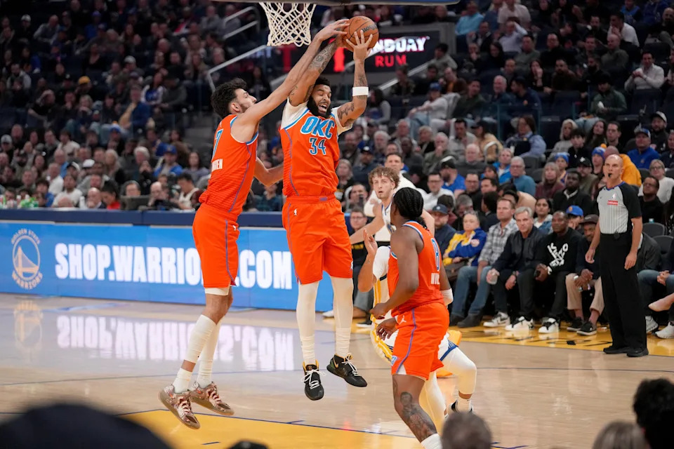 Dec 2, 2025; San Francisco, California, USA; Oklahoma City Thunder guard Kenrich Williams (34) holds onto a rebound next to center Chet Holmgren (7) against the Golden State Warriors in the second quarter at the Chase Center. Mandatory Credit: Cary Edmondson-Imagn Images