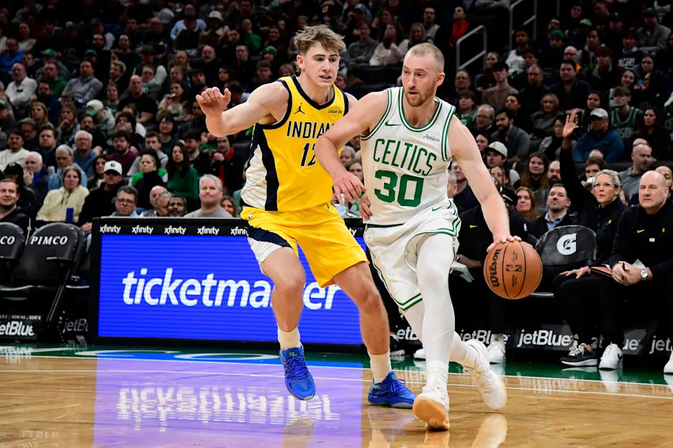 Dec 22, 2025; Boston, Massachusetts, USA; Boston Celtics forward Sam Hauser (30) controls the ball while Indiana Pacers guard Johnny Furphy (12) defends during the first half at TD Garden. Mandatory Credit: Bob DeChiara-Imagn Images